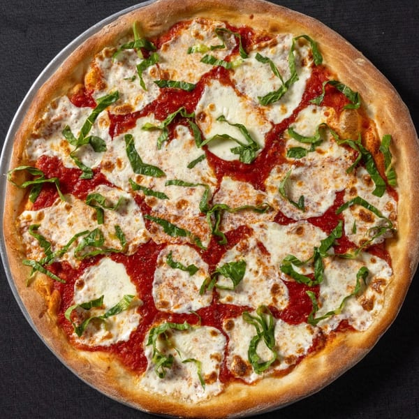 Vinnie's Pizzeria's Margherita pizza, featuring fresh mozzarella, vibrant tomato sauce, and basil on a crispy crust.