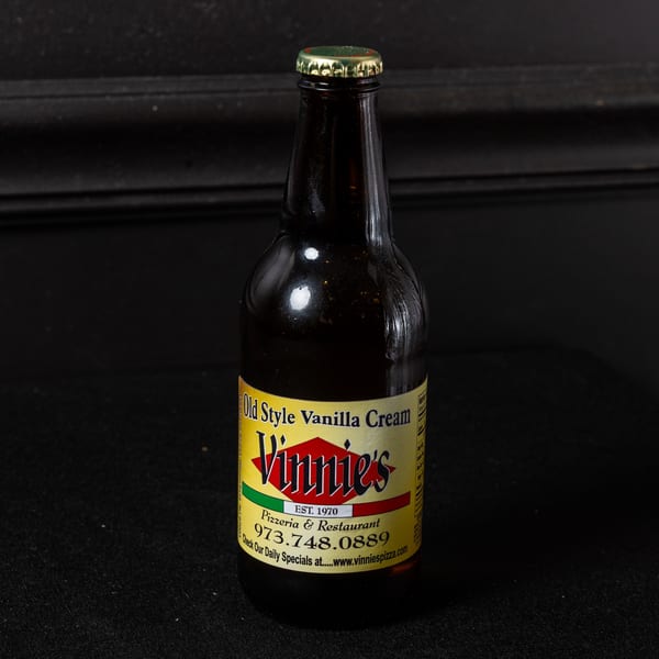 A bottle of Vinnie's Old Style Vanilla Cream soda with a yellow and red label.