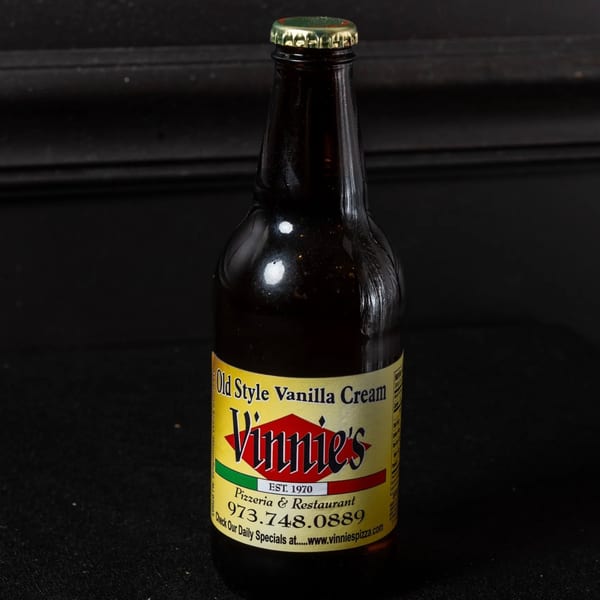 A bottle of Vinnie's Old Style Vanilla Cream soda with a yellow and red label.