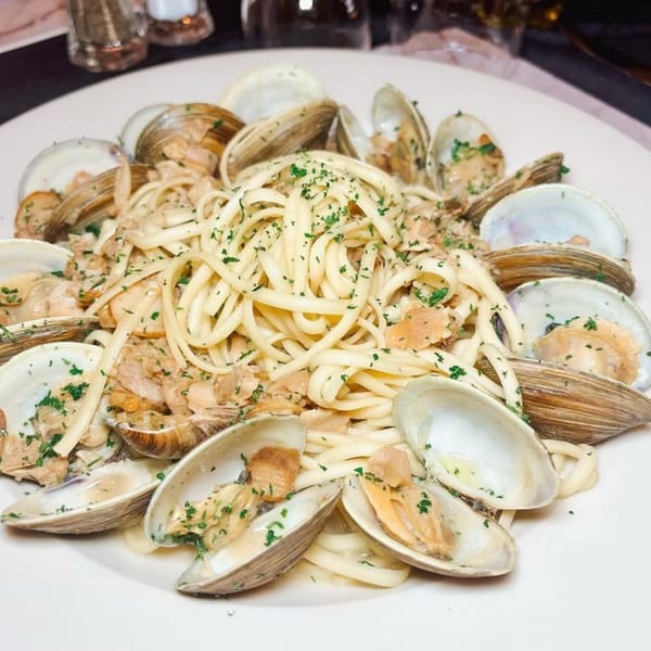 Linguine with clams and parsley in a white wine sauce on a white plate at Vinnie's Pizzeria.